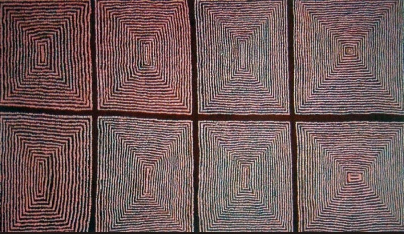 Ronnie Tjampitjinpa Tingari Cycle 1998 painting, featuring eight large concentric rectangular forms outlined with closely spaced red, white and dark lines on a black ground.