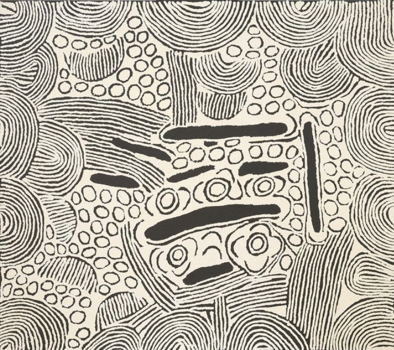 Black and white Aboriginal painting by Ningura Napurrula filled with dense curved parallel lines, clusters of small outlined circles and elongated solid black forms. Several concentric circular motifs with adjoining U-shaped forms occupy the centre, surrounded by rounded and arch-like patterns extending to the edges.