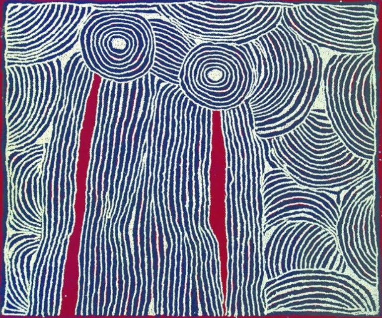 Blue, white and red Aboriginal painting by Ningura Napurrula with two large concentric circles near the top connected to long vertical fields of closely spaced white lines. Narrow red channels descend from the circles through the linear bands, while large semicircular and curved forms filled with repeated white lines surround the central design.