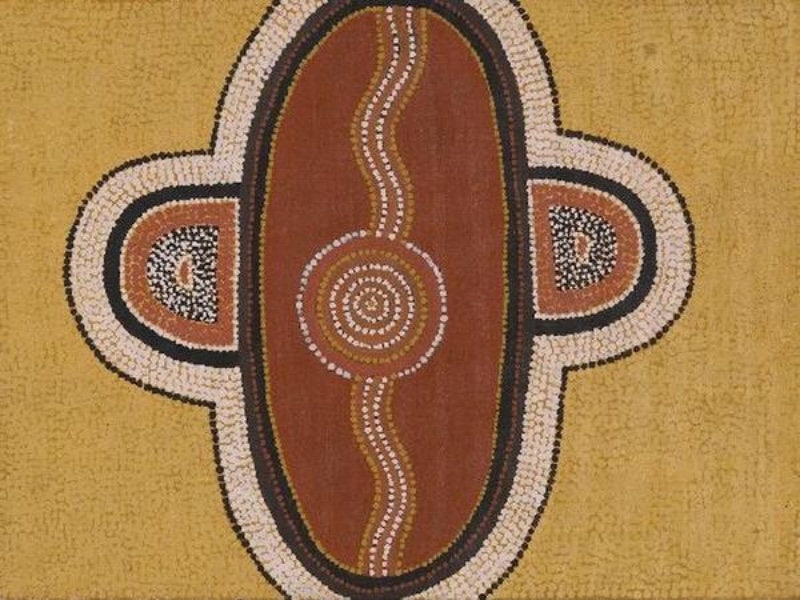 Turkey Tolson Tjupurrula Snake Dreaming, 1985. Aboriginal painting with a large central oval enclosing a concentric circle and wavy line, flanked by two smaller semicircular motifs on a yellow dotted background.