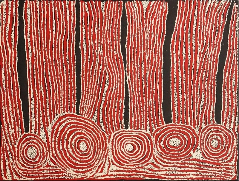Red, black and white Aboriginal painting by Ningura Napurrula with five concentric circular forms along the lower edge connected to long vertical bands of fine white dotted lines.
