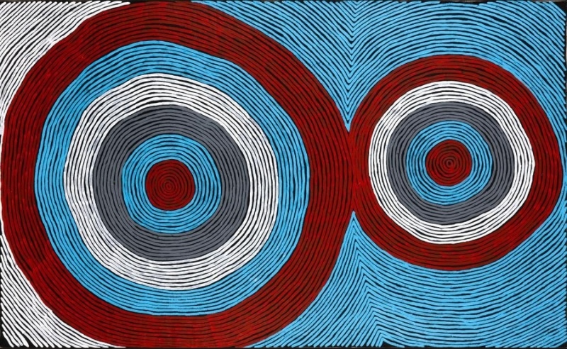 Ronnie Tjampitjinpa Tingari Cycle 2007 painting, with two large concentric circular forms in red, blue, grey, white and black surrounded by flowing parallel lines.