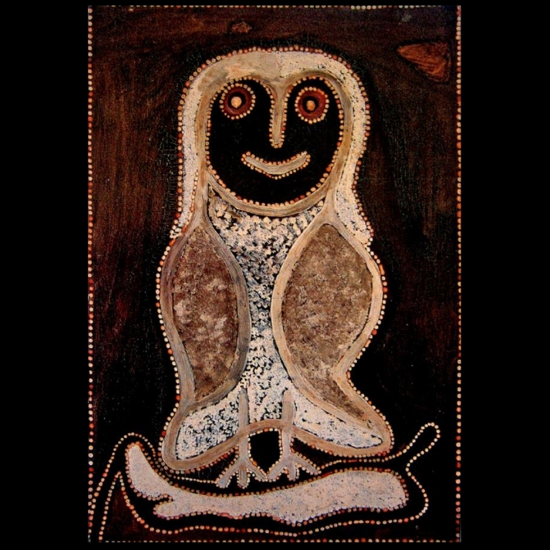 Rover Thomas ochre painting of a single large white and brown owl with a black face, standing above a pale elongated form on a dark brown ground.