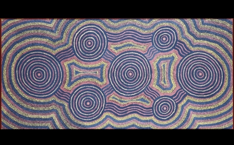 Turkey Tolson Tjupurrula Tingari Cycle, 1990. Aboriginal painting with large concentric circles connected by flowing parallel lines on a purple, blue, pink and yellow dotted background.