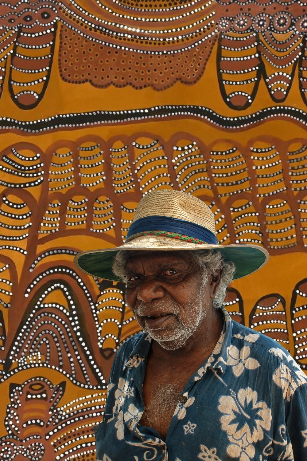 Jack Britten, Gija artist and Warmun ochre painter, photographed in front of one of his paintings.