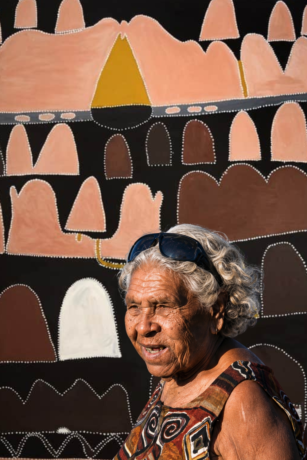 Queenie McKenzie – Gija Artist and East Kimberley Painter Queenie McKenzie with one of her distinctive East Kimberley landscape paintings