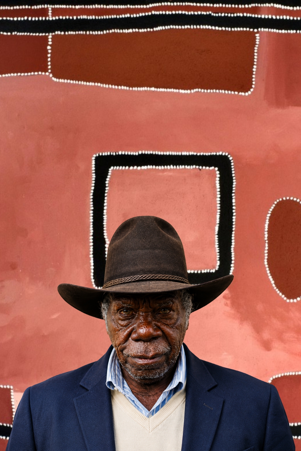 Rammey Ramsey – Gija Artist and East Kimberley Painter Rammey Ramsey with an East Kimberley ochre painting