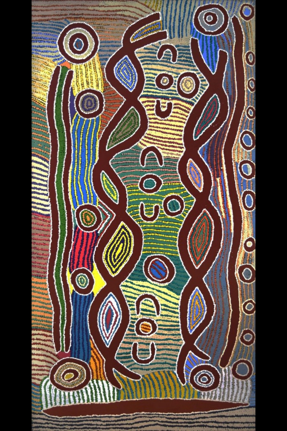 Maggie Watson Napangardi painting with concentric circles, U-shaped forms, long curving bands and repeated dotted lines in red, green, yellow, blue, ochre and white.