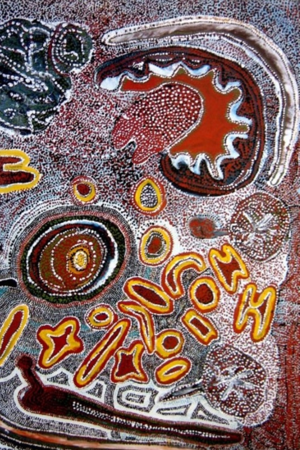 Wimmitji Tjapangarti painting with dense white dotting, concentric circles and irregular forms in red, yellow, black and ochre.