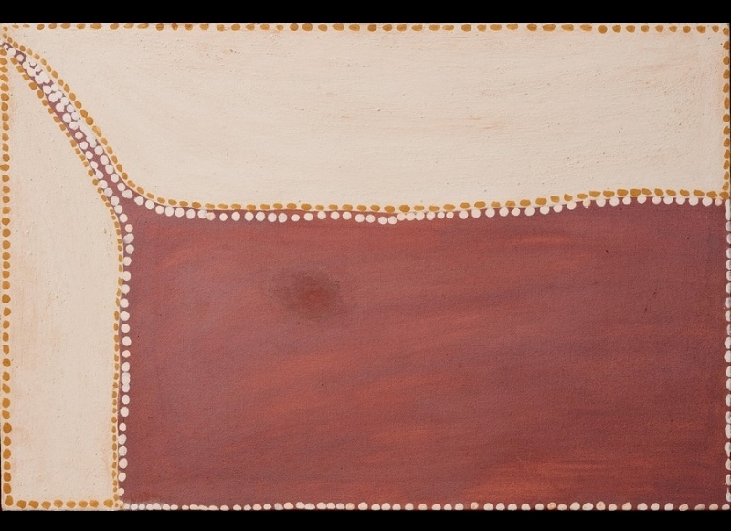 Rover Thomas painting divided into large areas of cream and muted red-brown ochre. A broad red-brown field fills the lower right, meeting a cream field across the top and left along an irregular curved boundary. Rows of white and golden ochre dots trace the boundary and frame the canvas.