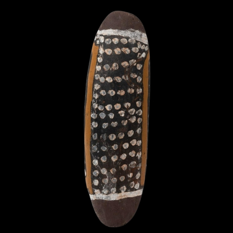 Rover Thomas Seed Carrying Vessel, c. 1995, carved wooden coolamon painted with black, white and ochre earth pigments and rows of white dots.