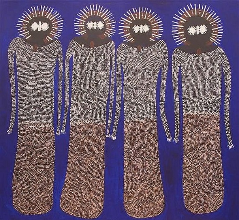 Jack Dale Mengenen painting of four tall Wandjina figures standing side by side against a vivid blue background, with dark rounded faces, radiating white halos and elongated bodies densely covered in fine white and ochre dots.