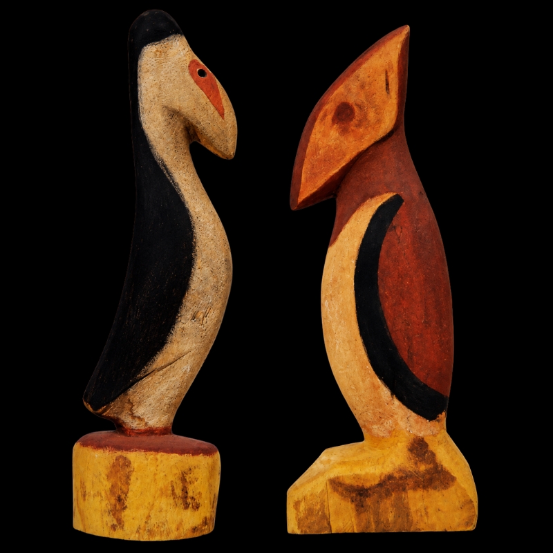 Two carved wooden figures by Hector Jandany representing Mary and Joseph, painted with black, white, yellow, red and brown earth pigments.