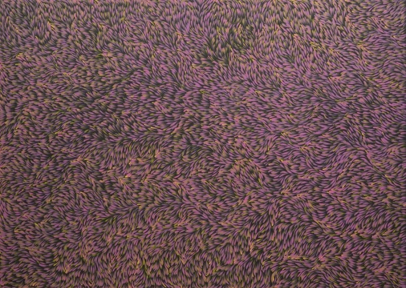 Gloria Petyarre painting densely covered with thousands of small pink, mauve and ochre leaf-shaped brush marks flowing in swirling patterns.