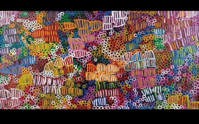 Large Minnie Pwerle painting densely filled with multicoloured striped forms and hundreds of small rings in pink, orange, green, blue, purple, yellow and white against a dark ground.