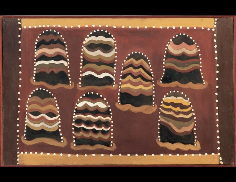 Hector Jandany ochre painting with seven rounded hill-like forms filled with wavy bands of red, yellow, white and black, each outlined with white dots on a red-brown ground.