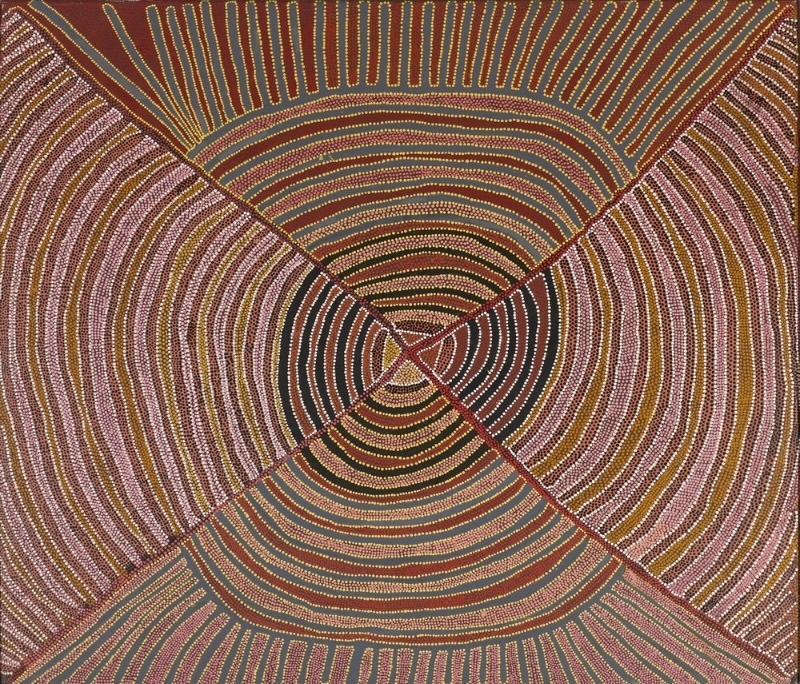 Painting by Gloria Petyarre with hundreds of curved dotted lines in pink, yellow, white and ochre radiating around a small central diamond.