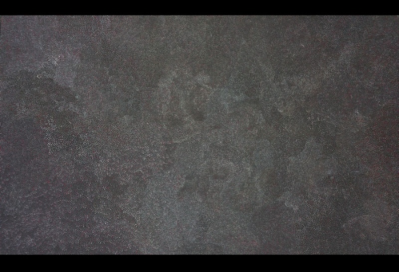 Awelye painting by Angelina Pwerle covered with thousands of extremely fine pale dots forming faint, cloud-like patterns across a dark grey ground.