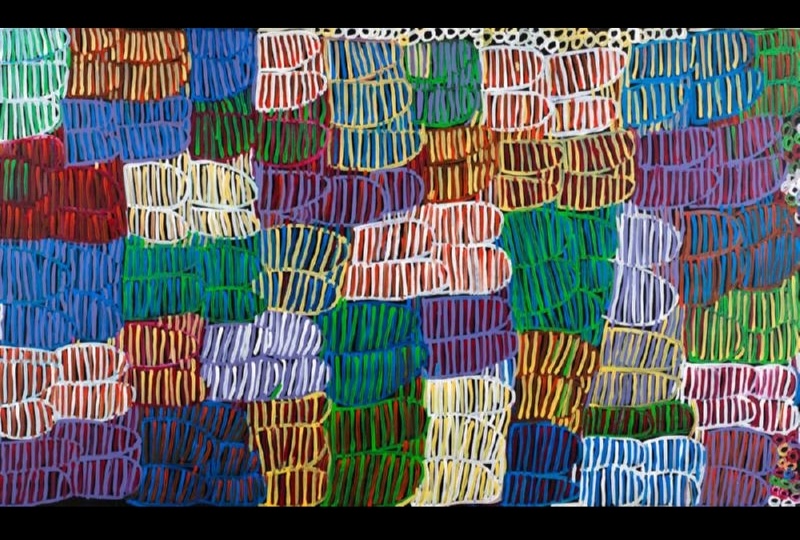 Minnie Pwerle Awelye Atnwengerrp painting with dense multicoloured striped forms in blue, green, red, purple, yellow and white.