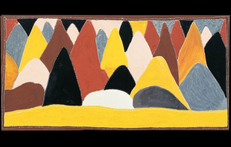 Queenie McKenzie ochre landscape filled with overlapping limestone hills in yellow, red, black, white and grey above a broad yellow foreground.