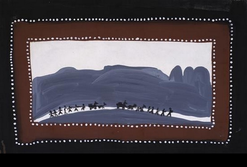 Jack Dale Mengenen painting of a donkey wagon and a line of small black human figures travelling along a pale track beneath large blue-grey Kimberley ranges, framed by brown and black borders with white dots.