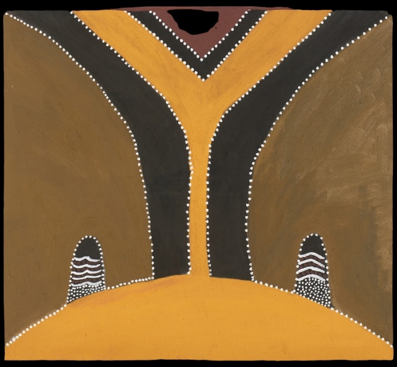 Hector Jandany Aboriginal ochre painting with a tall branching yellow form bordered by black bands and white dots, rising between two small striped hills on a brown ground.