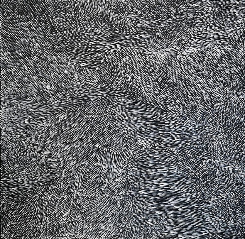 Large black-and-white painting by Gloria Petyarre filled with thousands of short white leaf-like strokes flowing in dense swirling bands across a black ground.
