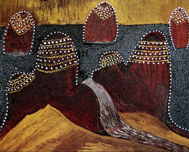 Hector Jandany ochre painting with clustered red-brown hills outlined and patterned with white dots, surrounding a pale winding watercourse beneath a yellow ochre sky.