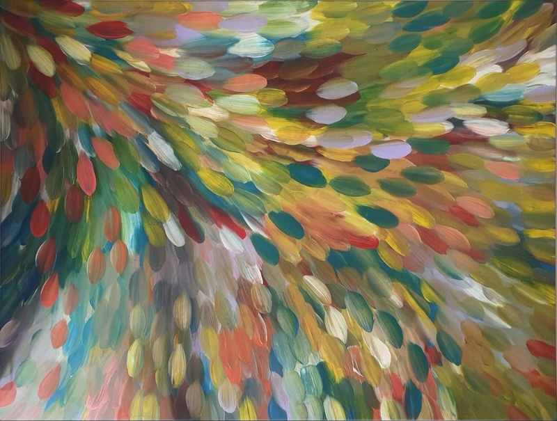 Gloria Petyarre painting with broad multicoloured leaf-shaped brushstrokes flowing in sweeping currents across the canvas.