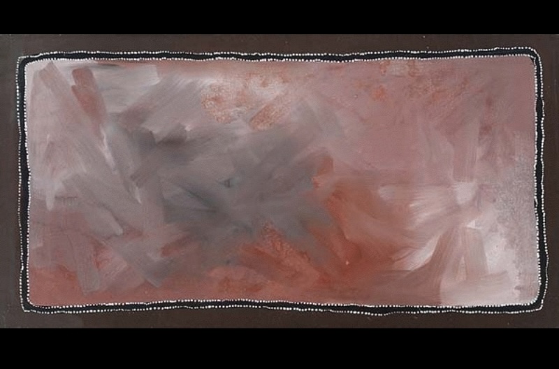 Rover Thomas painting with a large rectangular field of softly brushed pink, mauve, grey, red and pale cream earth colours. Broad overlapping brushstrokes create a cloudy, atmospheric surface, enclosed by a dark brown border edged with a fine line of white dots.