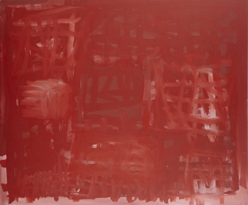 Rammey Ramsey painting almost entirely in shades of deep red and rust, built from overlapping rectangular patches and vigorous horizontal and vertical brushstrokes. Lighter pink and white marks emerge intermittently through the dense red surface.