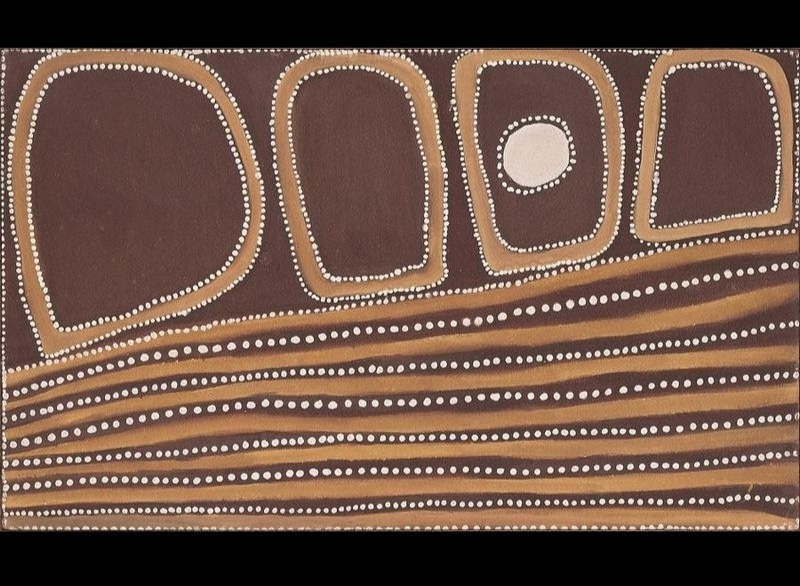 Rover Thomas painting in brown, golden ochre and white. Four large rounded shapes stand across the upper half, one containing a prominent white circle. Below them, numerous horizontal golden ochre bands and rows of large white dots flow across the canvas like layers of rock.