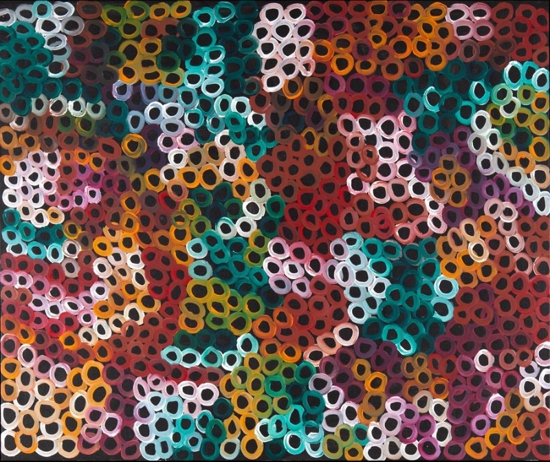 Minnie Pwerle painting densely covered with hundreds of small irregular rings in red, turquoise, pink, orange, green, purple, white and ochre against a dark ground.