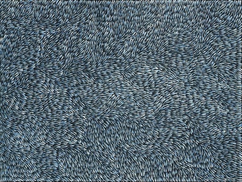 Gloria Petyarre painting of thousands of pale blue and white leaf-shaped brushstrokes flowing in dense swirling patterns across a dark ground.