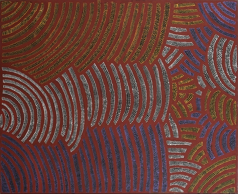 Painting by Gloria Petyarre with large curving bands of white, yellow, green, blue and purple dots arranged in contrasting sections on a red-brown ground.