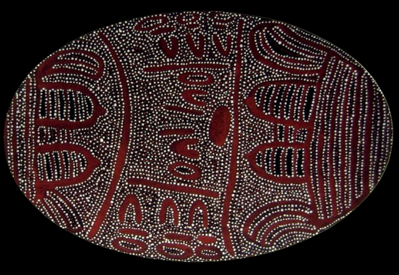 Oval painting by Gloria Petyarre with red-brown ceremonial forms, curved bands and seed-like shapes covered and outlined with dense white dots.