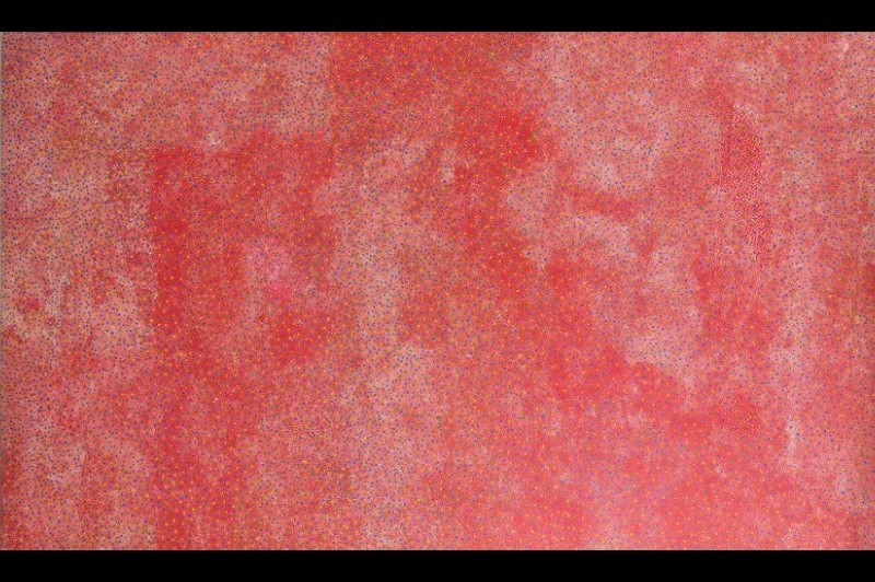 Bush Plum Dreaming painting by Angelina Pwerle, densely covered with tiny red, orange, pink and blue dots forming shifting fields across a vivid red ground.