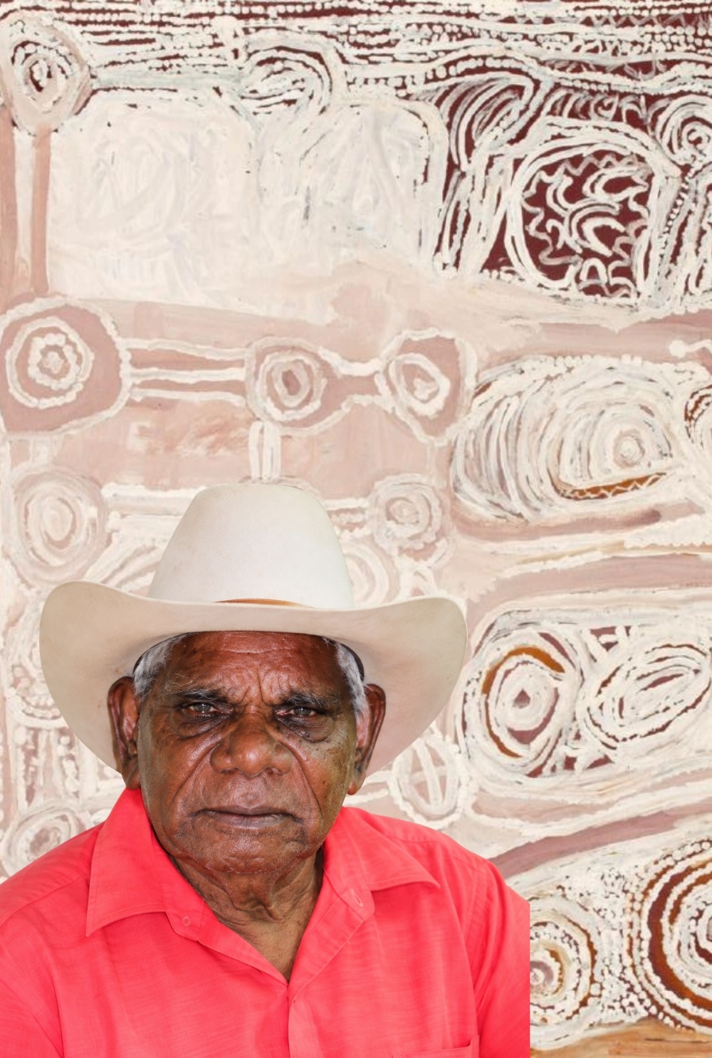 Billy Thomas Joongoorra – Wangkajunga Aboriginal Artist Billy Thomas Joongoorra wearing a white stockman’s hat, pictured in front of one of his ochre paintings.
