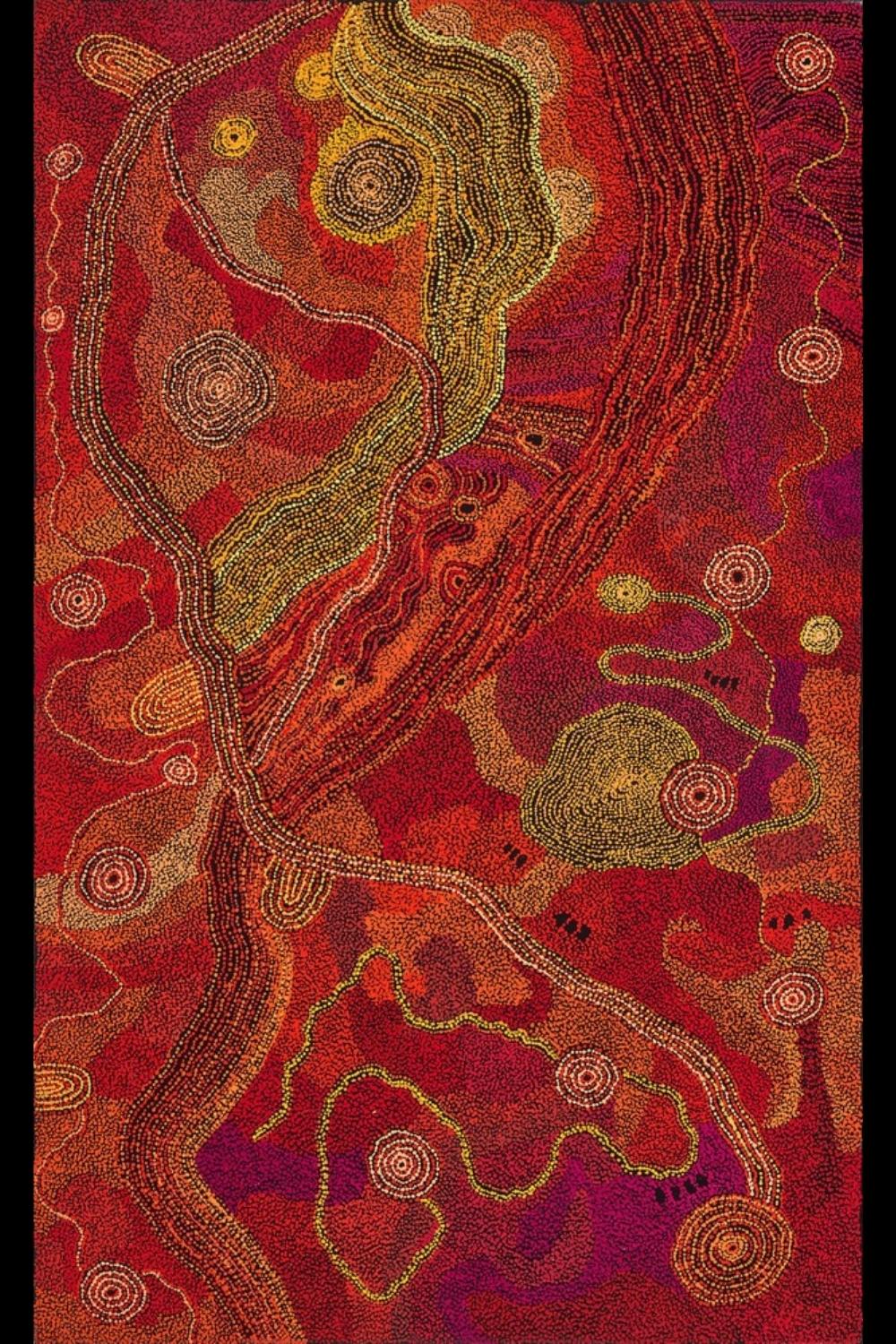 Tjungkara Ken’s Seven Sisters, 2015, with circular forms and winding lines across dense fields of red, orange, yellow and purple dots.