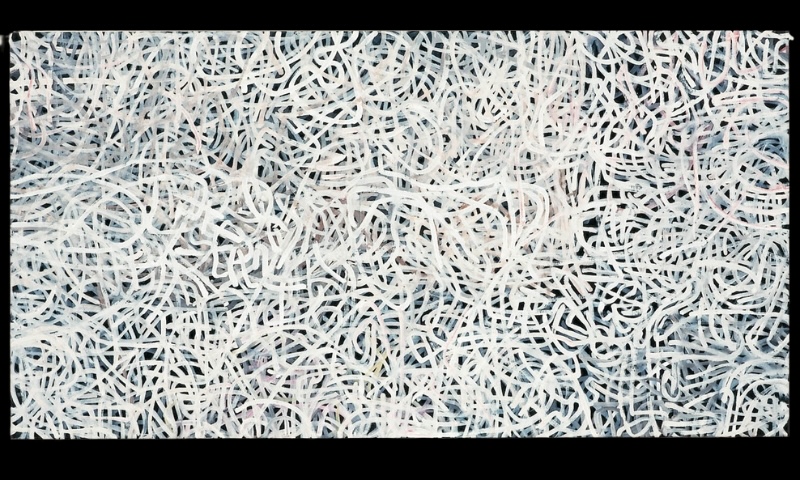 Emily Kame Kngwarreye’s Bush Yam Dreaming, c. 1994, with a dense network of looping and intersecting white lines covering a dark blue-grey ground.