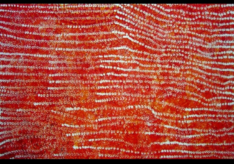 Emily Kame Kngwarreye’s Yam Country, 1995, with long parallel rows of white, cream and pale pink dots flowing and bending across a vivid red-orange ground.