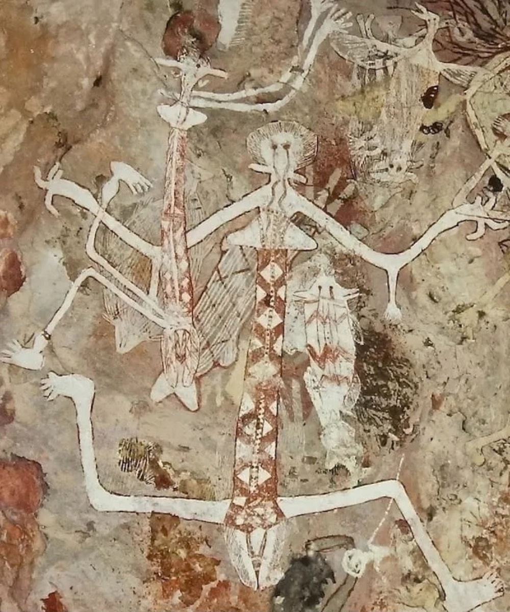 Aboriginal rock painting showing large white ancestral figures on a rock shelter wall in Arnhem Land