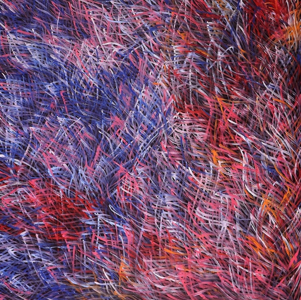 Barbara Weir Grass Seed painting with layered red, pink and blue lines. A densely worked painting filled with overlapping short and elongated lines in red, pink, blue, purple, white and orange. The coloured marks curve and cross one another in different directions, creating areas of swirling movement across the canvas.
