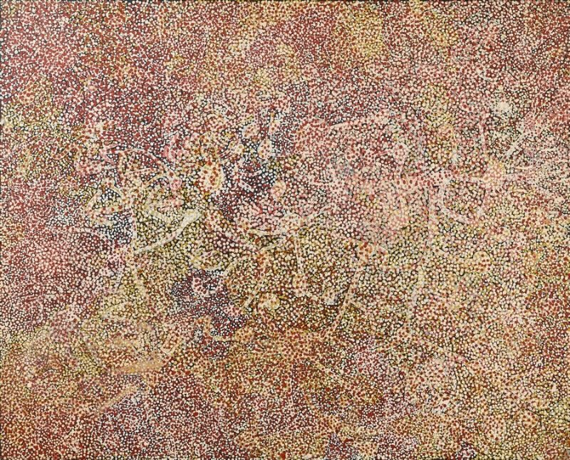 Emily Kame Kngwarreye’s Anooralya (Wild Yam), 1989, with dense red, yellow, white and pink dotting layered over pale meandering yam-root lines on a dark ground.