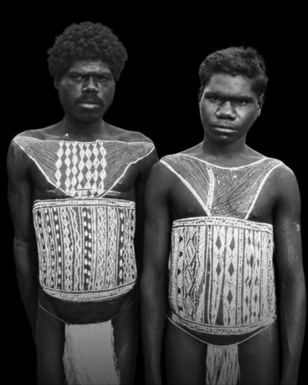 Two Aboriginal men with elaborate ceremonial body painting across their chests and torsos