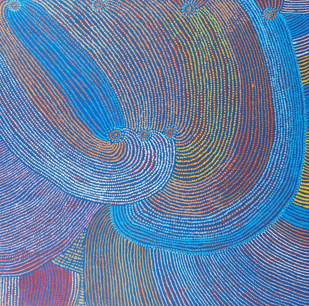 Tommy Mitchell's Walu Tjukurrpa painting (2008), featuring sweeping blue, orange and white dotted lines depicting ancestral Country in the Western Desert.