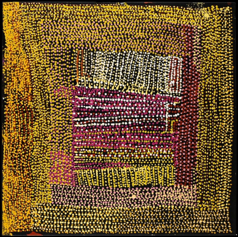 Tommy Mitchell's Warlpapuka painting depicting ancestral Country at Mount Fanny through dense yellow, pink and white dotting on a black background.